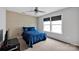 Cozy bedroom featuring a double window for natural light, ceiling fan, and patterned accent wall at 12517 Pine Terrace Ct, Charlotte, NC 28273