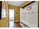 Entryway features wood floors, hooks, bench seating, and provides an open view to other rooms at 12517 Pine Terrace Ct, Charlotte, NC 28273