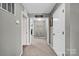 Inviting hallway with neutral walls, carpet flooring, and open sightlines into other rooms at 12517 Pine Terrace Ct, Charlotte, NC 28273