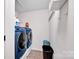 Functional laundry room with a modern washer and dryer, plus ample space for storage at 12517 Pine Terrace Ct, Charlotte, NC 28273