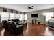 Cozy living room featuring hardwood floors, large windows, and modern furnishings at 12517 Pine Terrace Ct, Charlotte, NC 28273