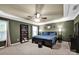Spacious bedroom with dark green walls, tray ceiling with fan, dark furniture, and great natural light at 12517 Pine Terrace Ct, Charlotte, NC 28273