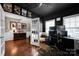 Stylish home office featuring hardwood floors, dark accents and ample shelving at 12517 Pine Terrace Ct, Charlotte, NC 28273