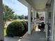Relaxing covered porch area with outdoor seating overlooking the front yard at 12517 Pine Terrace Ct, Charlotte, NC 28273