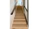 Carpeted staircase leads to the upper level of the home; featuring wooden handrails and white spindles at 12517 Pine Terrace Ct, Charlotte, NC 28273