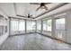 Bright sunroom with beadboard ceilings, tile floors, fan, and ample windows for natural light at 12517 Pine Terrace Ct, Charlotte, NC 28273