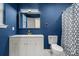 Stylish bathroom features a modern vanity, elegant gold-trimmed mirror, and geometric shower curtain at 130 Valley Glen Dr, Troutman, NC 28166