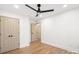 Cozy bedroom with hardwood floors, double closets, a ceiling fan, and neutral walls, offering a serene retreat at 130 Valley Glen Dr, Troutman, NC 28166
