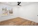 Bedroom featuring beautiful wood floors, a ceiling fan, and a large window offering plenty of natural light at 130 Valley Glen Dr, Troutman, NC 28166