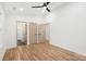 Bright bedroom with hardwood floors, ceiling fan, and multiple doorways at 130 Valley Glen Dr, Troutman, NC 28166