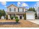 Beautiful two-story house with a well manicured front yard and a convenient attached garage at 130 Valley Glen Dr, Troutman, NC 28166