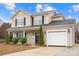 Charming two-story home with a well-maintained lawn, attractive landscaping, and an attached garage at 130 Valley Glen Dr, Troutman, NC 28166