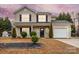 Lovely two-story home with a manicured lawn, mature trees, and an attached garage at 130 Valley Glen Dr, Troutman, NC 28166