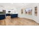 Bright, modern kitchen features white cabinets, stainless steel appliances, and an island with counter seating at 130 Valley Glen Dr, Troutman, NC 28166