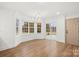 Bright living room with large windows, hardwood floors, and an elegant chandelier at 130 Valley Glen Dr, Troutman, NC 28166
