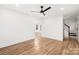 Open living room with wood floors, a ceiling fan, and ample natural light, creating a welcoming and spacious feel at 130 Valley Glen Dr, Troutman, NC 28166