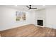 Bright living room with wood floors, a modern fireplace, and a large window providing lots of natural light at 130 Valley Glen Dr, Troutman, NC 28166