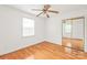 Bedroom featuring hardwood floors, natural light, and mirrored closet at 1320 Hartford Ave, Charlotte, NC 28209