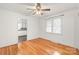 Bright bedroom with wood floors and neutral walls, adjacent to bright white kitchen at 1320 Hartford Ave, Charlotte, NC 28209