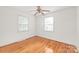 Sunny bedroom featuring hardwood floors and two bright windows at 1320 Hartford Ave, Charlotte, NC 28209