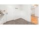 Bright entryway with coat hooks, gray tiled floors, and entrance to a room with hardwood floors at 1320 Hartford Ave, Charlotte, NC 28209