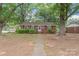 Charming brick home with black shutters, lush trees, and a walkway leading to the front door at 1320 Hartford Ave, Charlotte, NC 28209