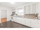 Bright kitchen with white cabinets, granite countertops, and stainless steel appliances at 1320 Hartford Ave, Charlotte, NC 28209