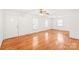 Spacious living room featuring hardwood floors, natural light, and a classic ceiling fan at 1320 Hartford Ave, Charlotte, NC 28209