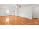Bright living room with gleaming hardwood floors and a large window letting in natural light at 1320 Hartford Ave, Charlotte, NC 28209