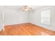 Cozy living room with hardwood floors, neutral walls, and ample natural light from a large window at 1320 Hartford Ave, Charlotte, NC 28209