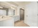 This bathroom includes a double vanity and large mirror at 14853 Santa Lucia Dr, Charlotte, NC 28277