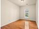 Cozy bedroom features neutral paint, hardwood flooring, window, and convenient electrical outlets for easy setup at 14853 Santa Lucia Dr, Charlotte, NC 28277