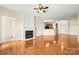 Spacious living room with hardwood floors, fireplace, and ceiling fan for comfortable living at 14853 Santa Lucia Dr, Charlotte, NC 28277