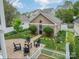 Private backyard with a cozy patio area, lush greenery, and detached home office, offering both relaxation and functionality at 16425 Spruell St, Huntersville, NC 28078