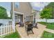 Backyard patio with outdoor seating and garden, creating an inviting space for relaxation and entertaining at 16425 Spruell St, Huntersville, NC 28078