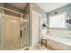 Bright bathroom features a shower with glass enclosure and a soaking tub at 16425 Spruell St, Huntersville, NC 28078