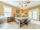Neutral-toned bedroom offers a ceiling fan and French doors to the exterior at 16425 Spruell St, Huntersville, NC 28078