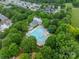 Aerial view of community pool and recreation center surrounded by lush greenery and neighborhood homes at 16425 Spruell St, Huntersville, NC 28078