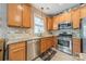 Eat-in kitchen boasts stainless steel appliances, tile backsplash, and granite countertops at 16425 Spruell St, Huntersville, NC 28078