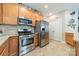 Well-lit kitchen features stainless steel appliances, granite countertops, and beautiful cabinetry at 16425 Spruell St, Huntersville, NC 28078