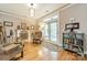 Cozy living room with hardwood floors, a fireplace, and french doors that opens to outdoor space, offering a comfortable retreat at 16425 Spruell St, Huntersville, NC 28078