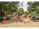 Community playground for , featuring swings, slides, and climbing structures on soft mulch ground at 16425 Spruell St, Huntersville, NC 28078