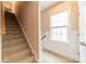 Carpeted stairway with white trim ascends to the upper level near a window with natural light at 16425 Spruell St, Huntersville, NC 28078