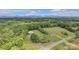 Expansive aerial view showcasing the lush green landscape, rolling hills, and surrounding mature trees at 1770 Nc 90 W Hwy, Taylorsville, NC 28681