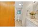 Bathroom with white vanity, light fixtures, neutral walls, and decorative flowers at 1770 Nc 90 W Hwy, Taylorsville, NC 28681