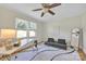Bedroom featuring hardwood floors, a sofa, an area rug, and two windows for ample light at 1770 Nc 90 W Hwy, Taylorsville, NC 28681