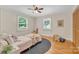 Bright bedroom features hardwood floors, two windows, a ceiling fan, and a closet at 1770 Nc 90 W Hwy, Taylorsville, NC 28681