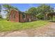 Side view of brick home with a deck and picnic table at 1770 Nc 90 W Hwy, Taylorsville, NC 28681