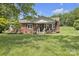 Charming brick home with a cozy front porch and beautifully landscaped front yard at 1770 Nc 90 W Hwy, Taylorsville, NC 28681