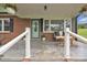Inviting front porch with seating, a decorative rug, and an attractively painted front door at 1770 Nc 90 W Hwy, Taylorsville, NC 28681